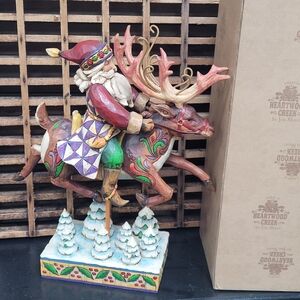 Jim Shore Festive Santa Riding Reindeer Figurine